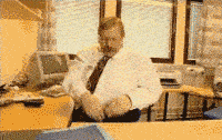 Angry man throwing things off his desk gif.